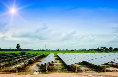 Scenic view of field against cloudy sky