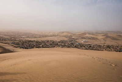 Scenic view or huacachina desert with houses