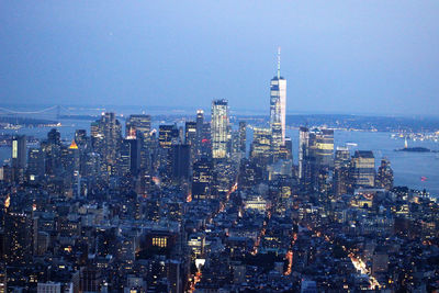 Aerial view of illuminated city buildings against sky