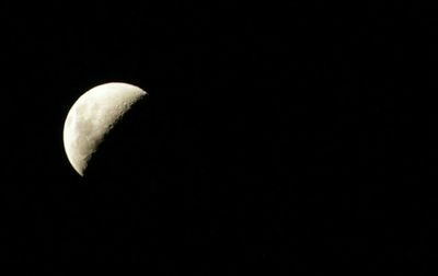 Low angle view of moon over black background