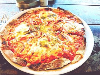 High angle view of pizza served on table at restaurant