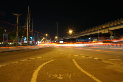 Light trails on road along buildings at night