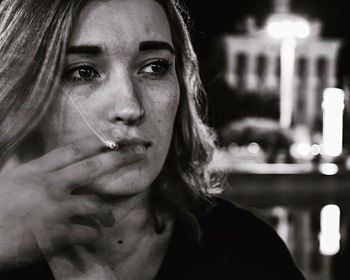 Close-up of thoughtful woman smoking cigarette