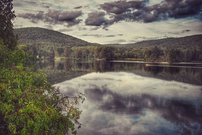 Scenic view of lake against cloudy sky