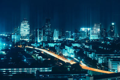 High angle view of city lit up at night