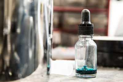 Close-up of glass bottle on table