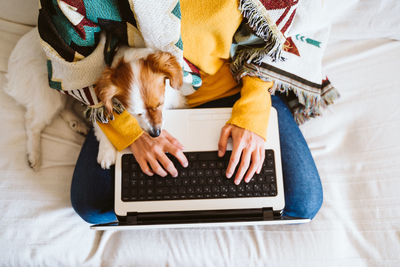 Portrait of a dog sitting on laptop