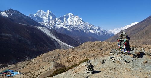 People on snowcapped mountain against sky