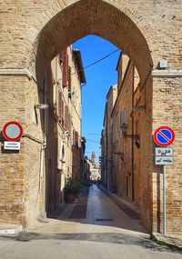 Road sign on street against buildings