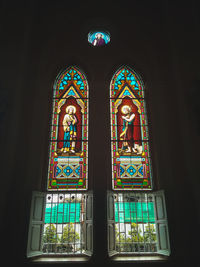 Low angle view of glass window of building