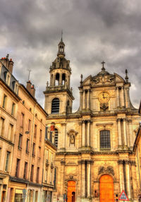 Low angle view of building against cloudy sky