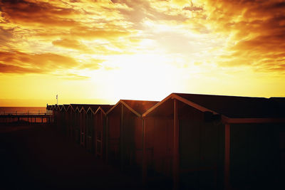 Fence against sky during sunset