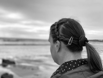 Rear view of woman looking out to sea