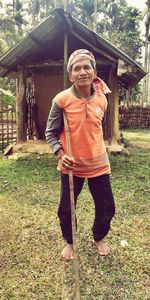 Portrait of man standing against wall