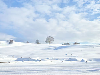 Scenic view of snowcapped landscape against sky