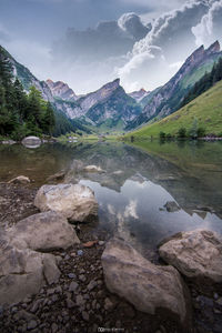 Scenic view of lake and mountains against sky