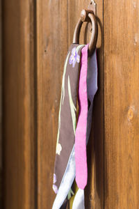 Close-up of pink hanging against wall