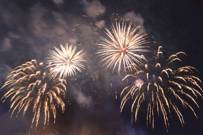 Bright fiery fireworks against the dark night sky in the smoke. horizontal photo