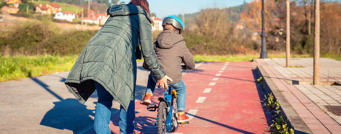 Rear view of couple kissing on footpath