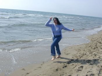 Full length of woman walking at beach