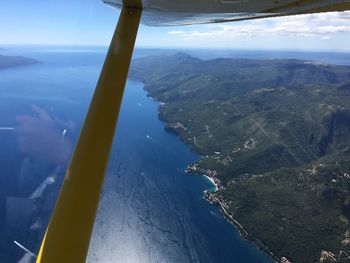 Aerial view of sea and mountains against sky