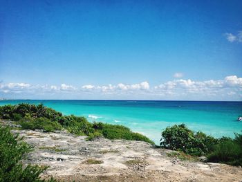 Scenic view of sea against blue sky