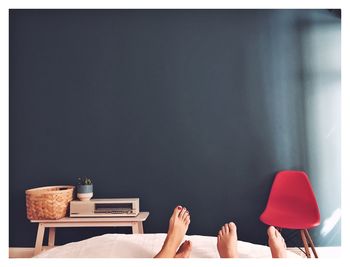 Low section of woman sitting on sofa