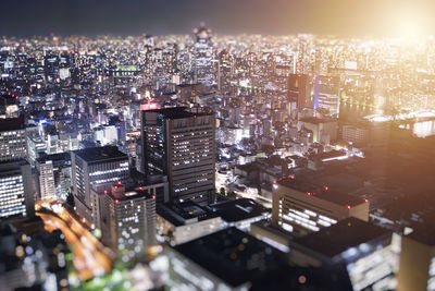 High angle view of illuminated city buildings against sky