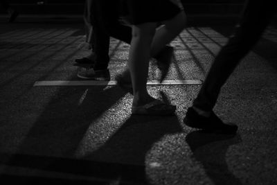 Low section of women standing on street