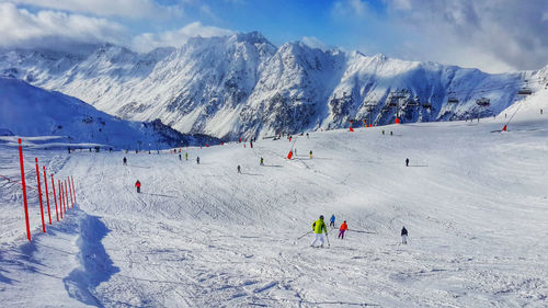 People skiing on snowcapped mountain