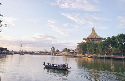 Boat in river against sky