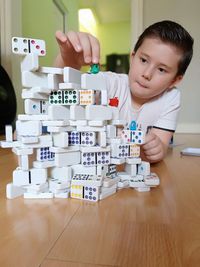 Portrait of boy playing with toy on table