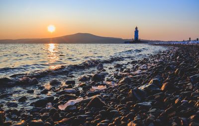 Scenic view of sea against sky at sunset