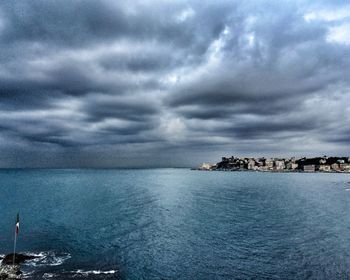 Scenic view of sea against cloudy sky