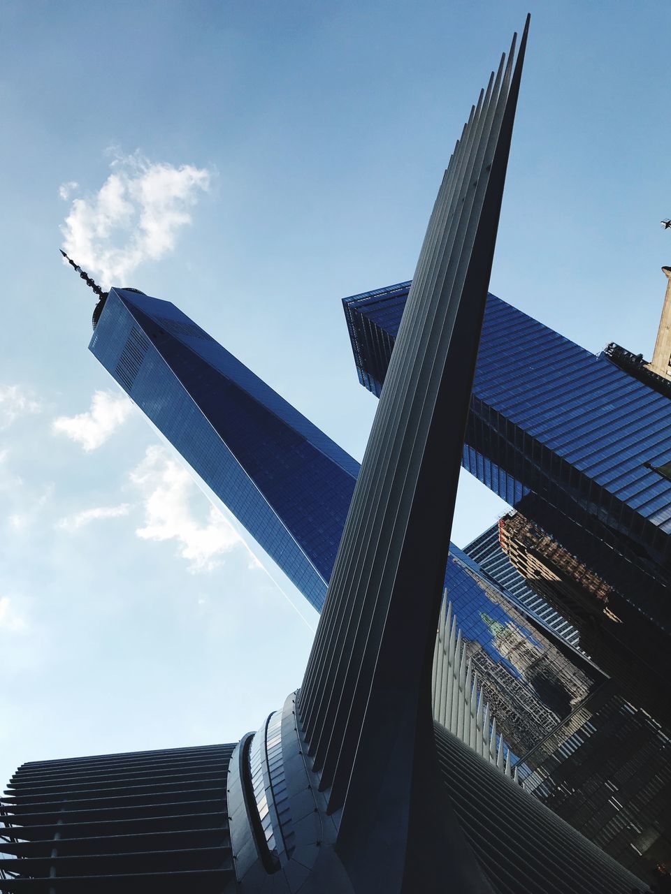 sky, low angle view, cloud - sky, architecture, built structure, building exterior, nature, no people, day, outdoors, city, building, modern, office, sunlight, office building exterior, tall - high, blue, skyscraper, travel destinations