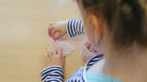 Young girl playing with bead toy