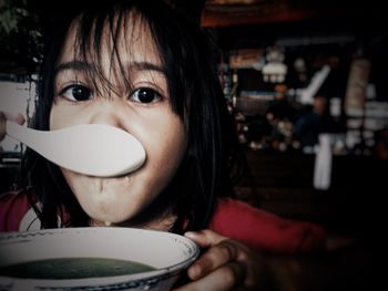 Portrait of girl drinking soup