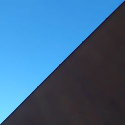 Low angle view of roof against clear blue sky