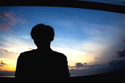 Silhouette people standing against sky at sunset