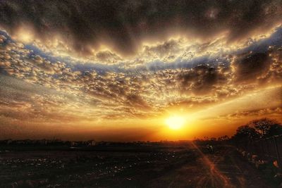 Scenic view of field against sky during sunset