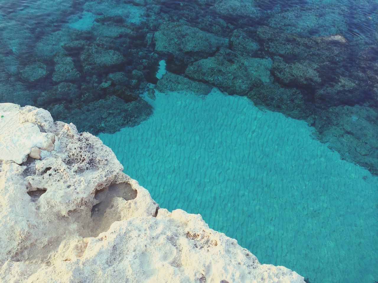 water, rock - object, rock formation, sea, beauty in nature, tranquility, blue, tranquil scene, scenics, high angle view, nature, rock, idyllic, geology, cliff, day, outdoors, physical geography, no people, rocky