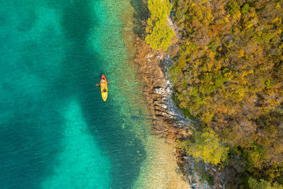 High angle view of people on rock in sea