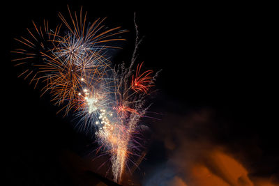 Low angle view of firework display at night