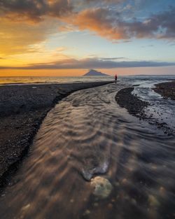 Scenic view of beach against sky during sunset