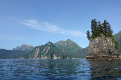 Scenic view of sea and mountains against sky