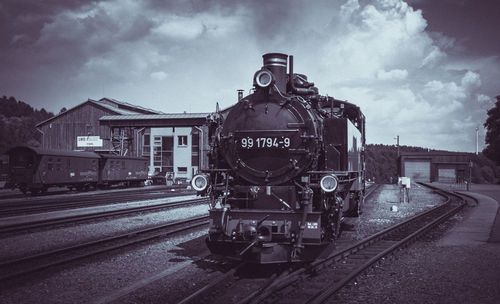 Train on railroad station against sky