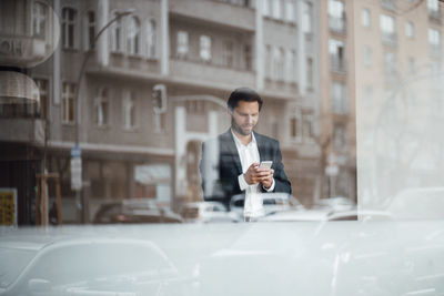Man looking at camera in city