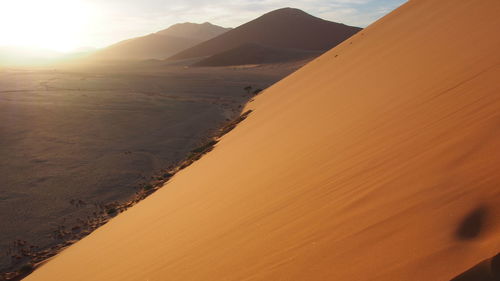 Scenic view of desert against sky during sunset