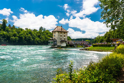 Beautiful, turquoise rhine river flowing from a waterfall in northern switzerland.