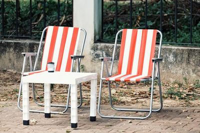 Empty chairs and tables in park